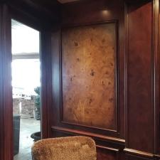 Faux burl and wood grained panels and mahogany wood grained walls with chair